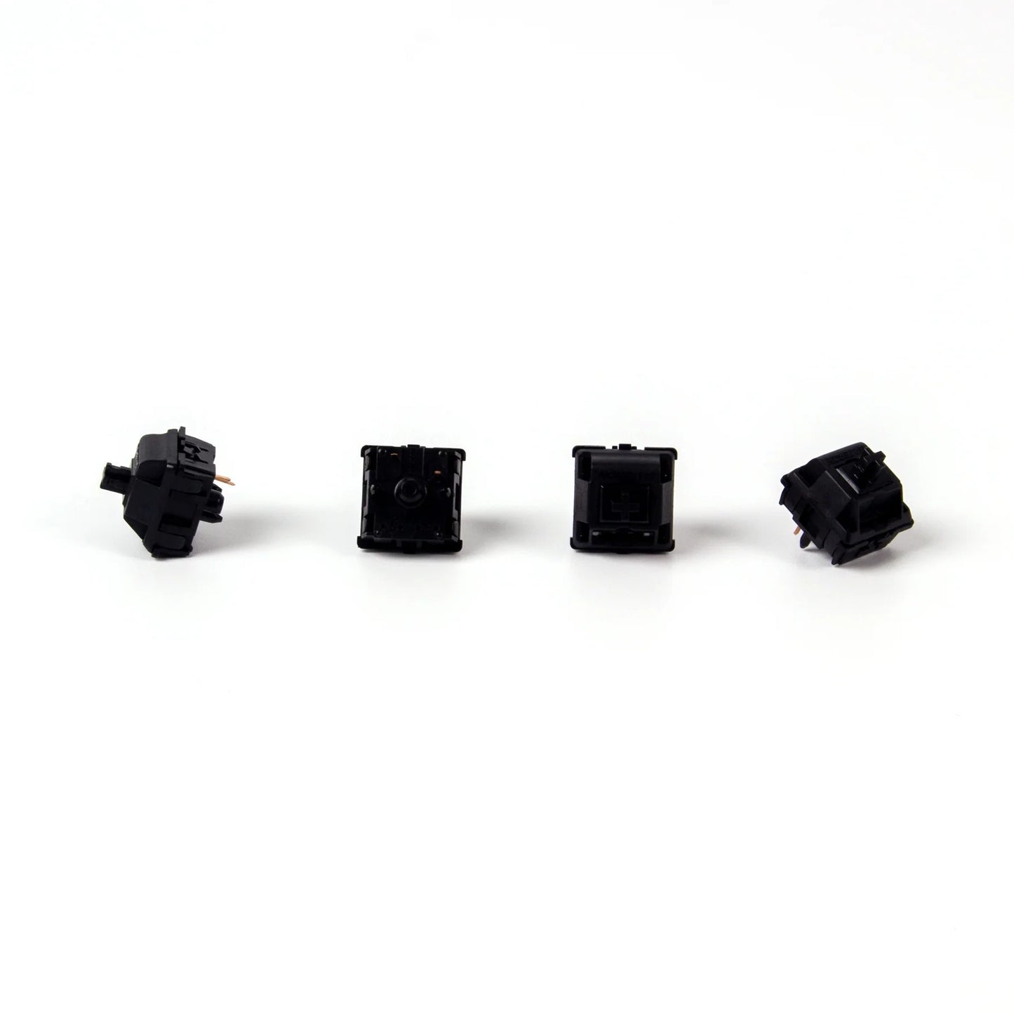 Four black mechanical keyboard switches arranged in a row on a white background. The switches are Gateron Oil King models, known for their smooth and quiet operation.