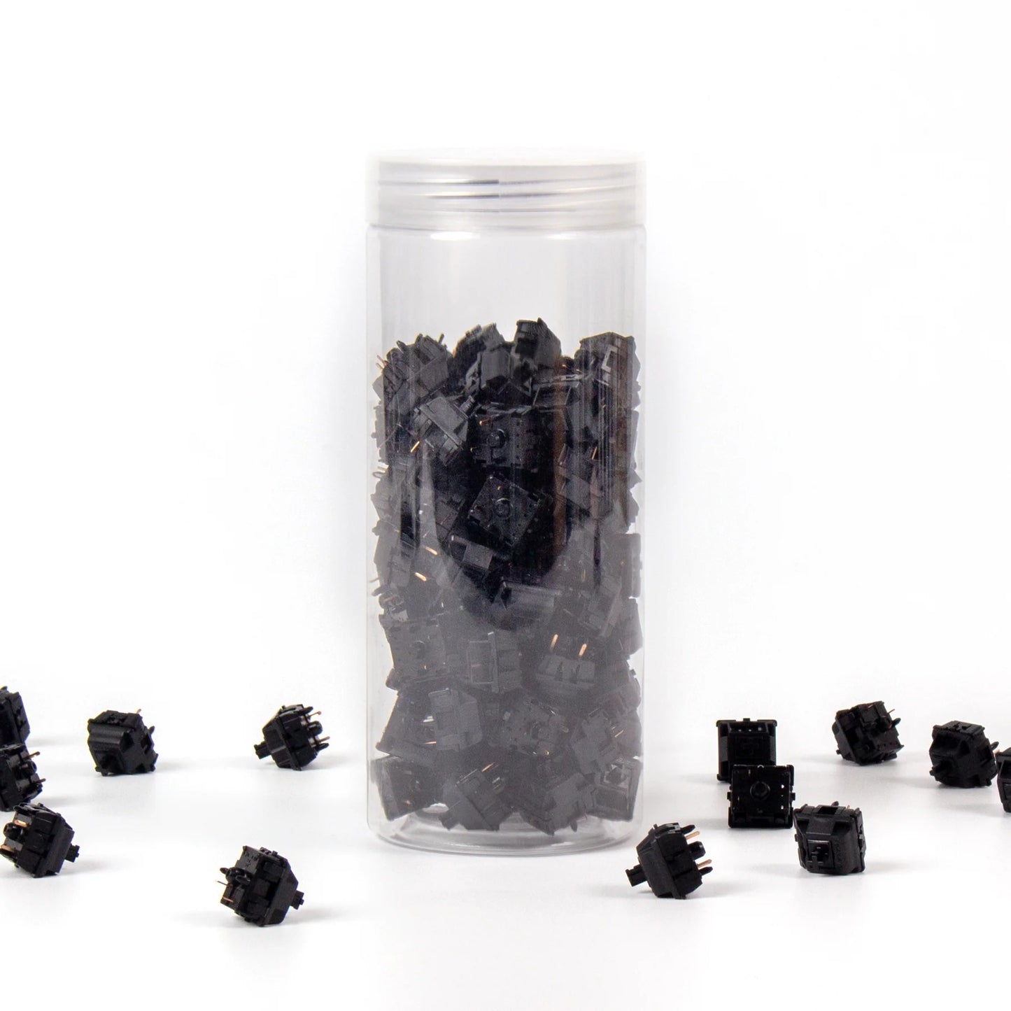 A clear plastic jar filled with black mechanical keyboard switches. The switches are Gateron Oil King models, known for their smooth and quiet operation.